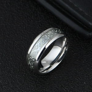 Luminous stainless steel dragon ring with glowing green Celtic pattern on black leather