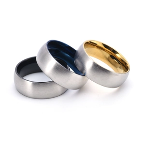 Detail of brushed titanium steel rings with black blue and gold inner plating finishes