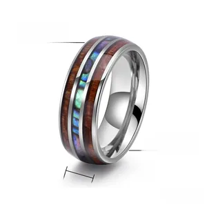 Macro detail of 8mm tungsten steel ring with wood and abalone shell inlay