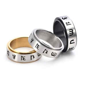 Detailed view of three-color stainless steel spinner rings with brushed finish and mantras