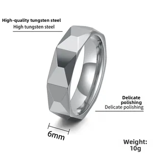 Detail of 6mm faceted tungsten steel ring showing polished geometric surface and 10g weight