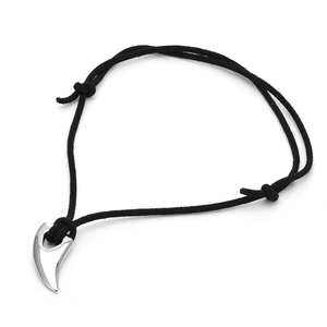 Macro view of silver bull horn pendant with adjustable black braided cord necklace