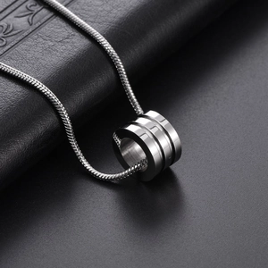 Titanium steel cylinder pendant necklace with a sleek snake chain on black leather