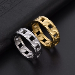 Polished silver and gold titanium steel Cuban link rings in a stack on black leather