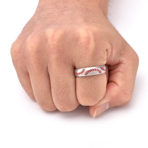 Detail of matte silver titanium baseball ring with red stitch pattern on male hand