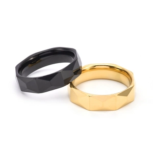 Detail of 6mm faceted tungsten steel rings in gold and black with geometric design