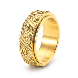 Macro view of gold spinner ring featuring engraved triangle and eye symbols