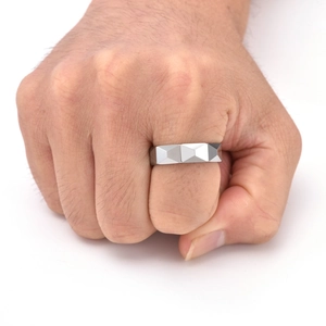 Detail of 6mm faceted tungsten steel ring showing masculine geometric design on hand