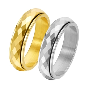 Close-up of titanium steel spinner rings with golden and silver rhombic texture finish