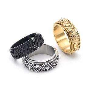 Detailed view of three vintage spinning rings with pyramid eye engraving in steel and gold