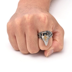 Detail of vintage Anubis steel ring with golden Ankh symbol on hand in high quality