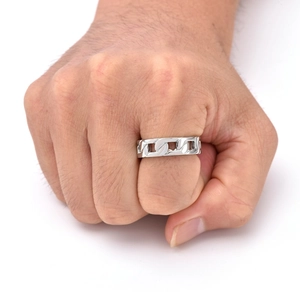 Macro shot of silver titanium steel cuban link chain ring on male hand with white background