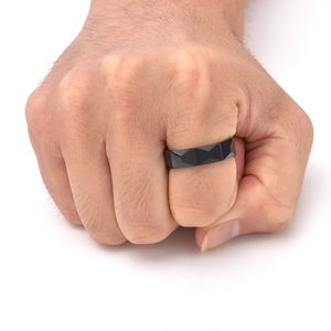 Detail of a 6mm faceted black tungsten ring for men featuring geometric rhombus surface