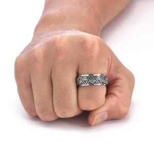 Detailed view of vintage titanium steel ring with Eye of Providence engraving on a hand