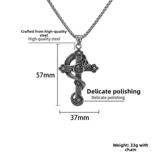 Detail of vintage gothic skull and dragon cross pendant in polished titanium steel