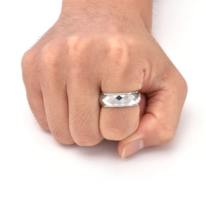 Macro detail of silver geometric rhombus cut rotating ring on a male hand