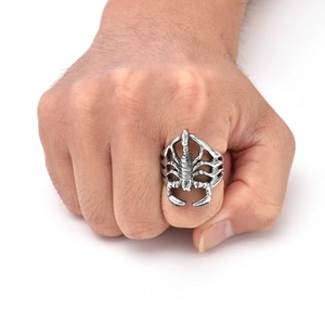 Close-up of a retro punk scorpion ring on a male hand with vintage steel finish