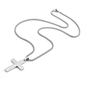 Macro shot of silver hammer-textured cross pendant with durable steel box chain