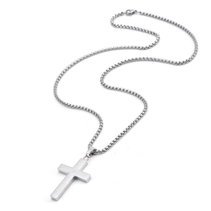 Detailed macro view of silver stainless steel cross pendant with engraved Lord Prayer text