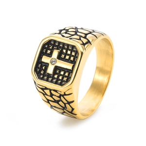 Macro detail of men's gold signet ring featuring a black textured cross and stone