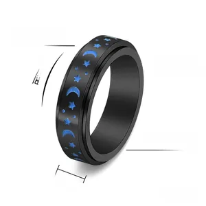 Detailed view of a 6mm black stainless steel spinner ring with blue moon and star patterns