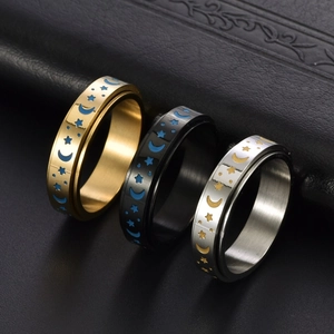 Stainless steel spinning moon and star rings in gold, black, and silver finishes