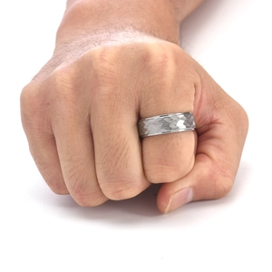 Macro detail of the hammered texture and reflective surface on this men's tungsten ring