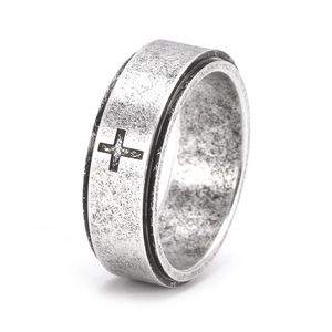 Detail of 8mm rotating spinner ring in vintage steel finish featuring a black cross motif