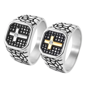 Detail of silver and gold cross rings with rock crack texture and zircon inlays
