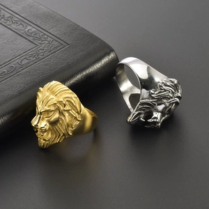 Detail of gold and silver lion head rings in punk style with polished finish