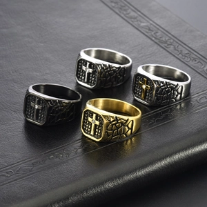 Detail of vintage stainless steel cross rings with cracked texture and small diamond inlay