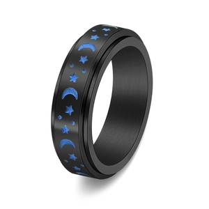 Close-up of black stainless steel spinner ring with blue moon and star brushed finish