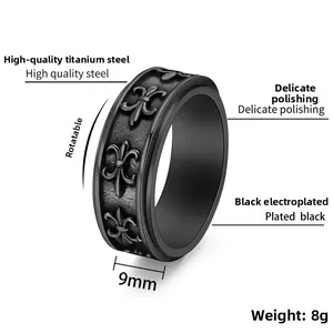 Detailed view of a 9mm black spinning ring with embossed fleur-de-lis motifs