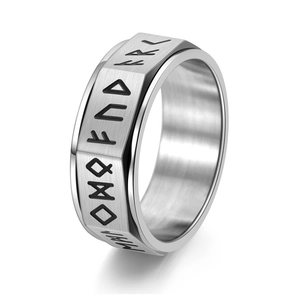 Detail of vintage Viking spinner ring with engraved Norse runes on silver steel band