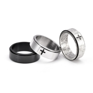 Three-piece spinner ring set in black, silver, and antique steel with engraved crosses