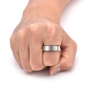 Macro shot of 8mm wide rotatable titanium steel ring with vintage cross on a male hand
