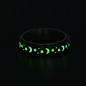 Luminous stainless steel rotating ring featuring glowing star and moon patterns