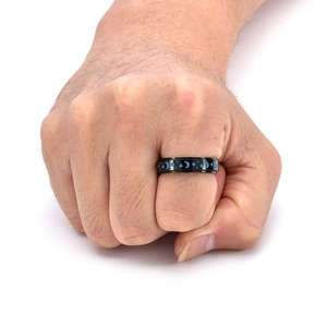 Detailed view of black stainless steel spinning ring with blue star and moon celestial patterns