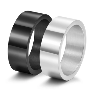 Close-up of set of two wide titanium steel rings in polished black and silver finishes