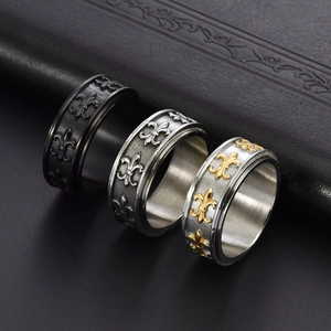Vintage titanium steel men's spinner ring with fleur-de-lis reliefs in three metal finishes