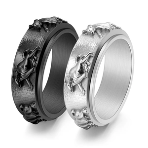 Detail of relief bull pattern on matte black and silver polished stainless steel rings