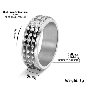 Detail view of 8mm rotatable titanium steel ring with silver pyramid rivet texture
