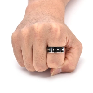 Detail of stainless steel cross ring with black enamel inlay on a male model's finger