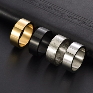 Set of four minimalist men's rings in gold, black, and vintage steel on black leather