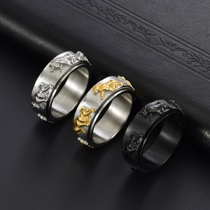 Three men's titanium bull head rotating rings in silver, gold, and black finishes