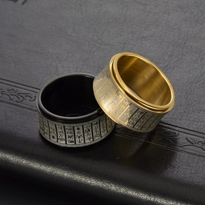 Rotating stainless steel rings in gold and black with engraved spiritual characters