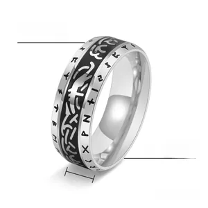 Macro detail of 8mm Viking rune ring showing black Celtic knot and silver steel texture