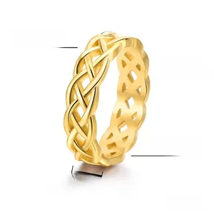 Macro detail of 6mm gold plated titanium steel ring with Celtic knot hollow weave pattern