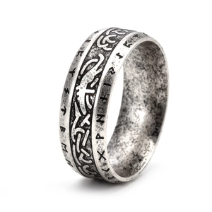 Macro detail of vintage Viking rune ring with Nordic Celtic knotwork in antique silver