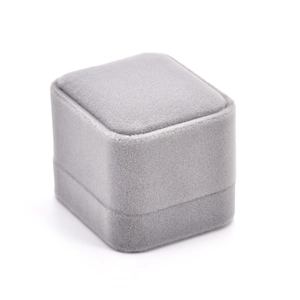 Close-up of a minimalist grey velvet jewelry box for rings with a soft matte texture